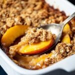 The Ultimate Guide to Making the Perfect Peach Crisp 5 Close-up of peach crisp with golden oat crumble topping and juicy peach filling in a white baking dish