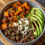 High-Protein Ground Beef & Hot Honey Meal Prep Bowl 7 Overhead view of ground beef hot honey bowl featuring roasted sweet potatoes, avocado slices, and crumbled cheese drizzled with hot honey.