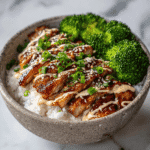 Sticky Chicken Bowls: The Ultimate Sweet & Savory Meal Prep Hero 5 A close-up of a sticky chicken bowls with glazed chicken, steamed broccoli, sesame seeds, and green onions over white rice