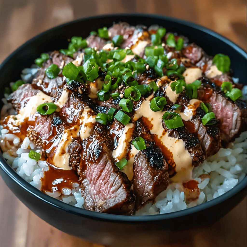 Korean BBQ Steak Rice Bowl: The Ultimate Flavor-Packed Guide 3 Close-up of a Korean BBQ Steak Rice Bowl topped with creamy gochujang sauce, grilled steak slices, green onions, and sesame glaze over sticky rice